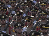 Members of the Iranian Army's land force march in a military parade commemorating the anniversary of the Iran-Iraq War (1980-88) outside the...