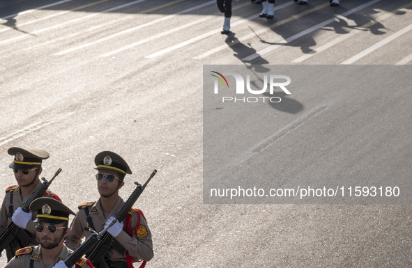 Members of the Iranian Army's land force march in a military parade commemorating the anniversary of the Iran-Iraq War (1980-88) outside the...