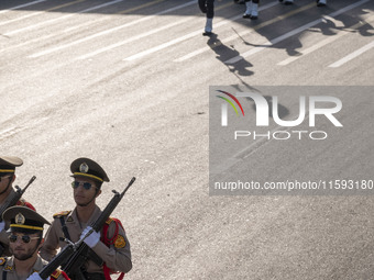 Members of the Iranian Army's land force march in a military parade commemorating the anniversary of the Iran-Iraq War (1980-88) outside the...