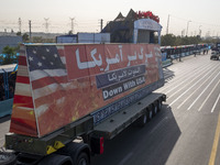 A truck carries a giant anti-U.S. banner during a military parade commemorating the anniversary of the Iran-Iraq War (1980-88) outside the K...