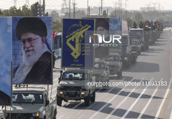 Portraits of Iran's Supreme Leader, Ayatollah Ali Khamenei, and a badge of the Islamic Revolutionary Guard Corps (IRGC), are carried by mili...