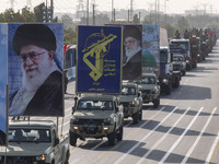 Portraits of Iran's Supreme Leader, Ayatollah Ali Khamenei, and a badge of the Islamic Revolutionary Guard Corps (IRGC), are carried by mili...