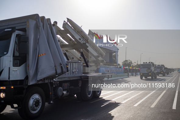 An Iran-made missile is carried by a truck during a military parade commemorating the anniversary of the Iran-Iraq War (1980-88) outside the...