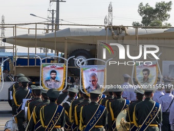 An Iranian ballistic missile is carried past a portrait of former commander of the Islamic Revolutionary Guard Corps' (IRGC) Quds Force, Gen...