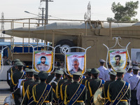 An Iranian ballistic missile is carried past a portrait of former commander of the Islamic Revolutionary Guard Corps' (IRGC) Quds Force, Gen...