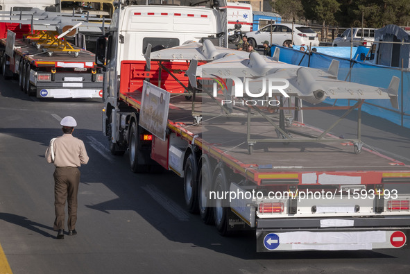 Iranian-made unmanned aerial vehicles (UAV), the Shahed-136, which are equipped with jet engines, are carried by a truck during a military p...