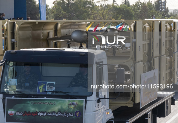 An Iranian-made unmanned aerial vehicle (UAV), the Shahed-136, is carried by a truck during a military parade commemorating the anniversary...