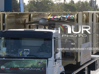 An Iranian-made unmanned aerial vehicle (UAV), the Shahed-136, is carried by a truck during a military parade commemorating the anniversary...