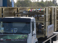 An Iranian-made unmanned aerial vehicle (UAV), the Shahed-136, is carried by a truck during a military parade commemorating the anniversary...