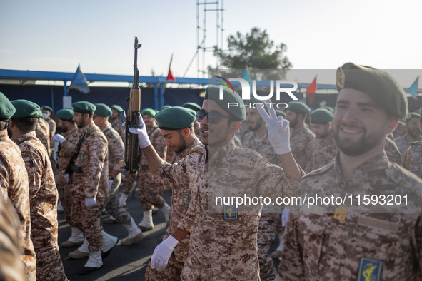 An armed Islamic Revolutionary Guard Corps (IRGC) military personnel flashes a Victory sign after marching in a military parade commemoratin...