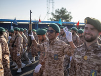 An armed Islamic Revolutionary Guard Corps (IRGC) military personnel flashes a Victory sign after marching in a military parade commemoratin...