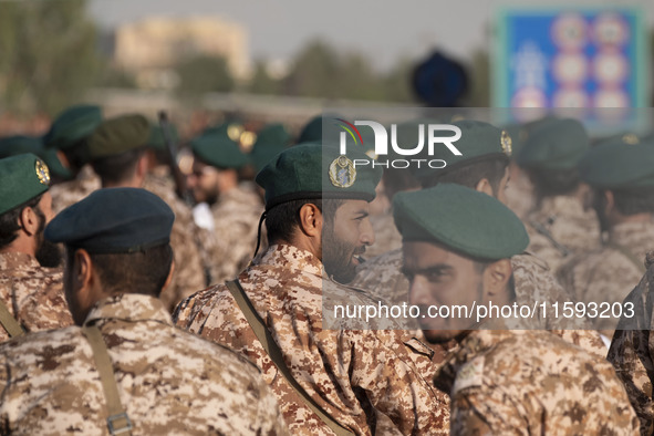 An Islamic Revolutionary Guard Corps (IRGC) military personnel looks on after marching in a military parade commemorating the anniversary of...