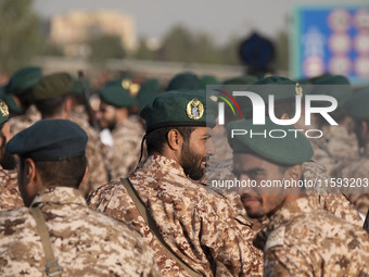 An Islamic Revolutionary Guard Corps (IRGC) military personnel looks on after marching in a military parade commemorating the anniversary of...