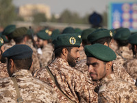 An Islamic Revolutionary Guard Corps (IRGC) military personnel looks on after marching in a military parade commemorating the anniversary of...