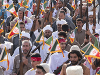 Armed members of the Basij Paramilitary Force, which is under the command of the Islamic Revolutionary Guard Corps, hold up their rifles aft...