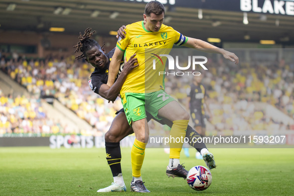 Kenny McLean of Norwich City is pressured by Tom Dele-Bashiru of Watford during the Sky Bet Championship match between Norwich City and Watf...