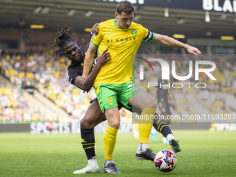 Kenny McLean of Norwich City is pressured by Tom Dele-Bashiru of Watford during the Sky Bet Championship match between Norwich City and Watf...