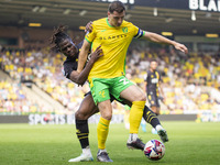 Kenny McLean of Norwich City is pressured by Tom Dele-Bashiru of Watford during the Sky Bet Championship match between Norwich City and Watf...