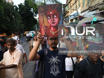 Indian artists protest with their paintings while they shout slogans during a protest rally against the rape and murder of a PGT woman docto...