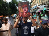 Indian artists protest with their paintings while they shout slogans during a protest rally against the rape and murder of a PGT woman docto...