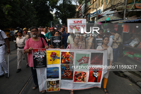 Indian artists protest with their paintings while they shout slogans during a protest rally against the rape and murder of a PGT woman docto...