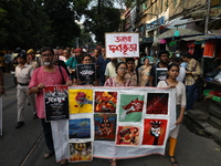 Indian artists protest with their paintings while they shout slogans during a protest rally against the rape and murder of a PGT woman docto...