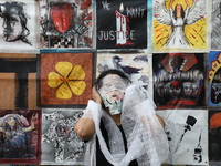 An Indian artist performs as she protests during a rally against the rape and murder of a PGT woman doctor at the government-run R G Kar Med...