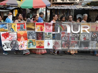 Indian artists protest with their paintings while they shout slogans during a protest rally against the rape and murder of a PGT woman docto...