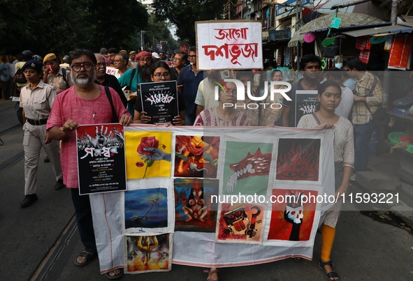 Indian artists protest with their paintings while they shout slogans during a protest rally against the rape and murder of a PGT woman docto...