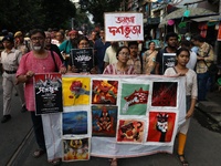 Indian artists protest with their paintings while they shout slogans during a protest rally against the rape and murder of a PGT woman docto...