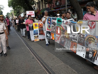 Indian artists protest with their paintings while they shout slogans during a protest rally against the rape and murder of a PGT woman docto...