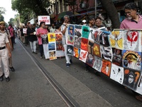 Indian artists protest with their paintings while they shout slogans during a protest rally against the rape and murder of a PGT woman docto...