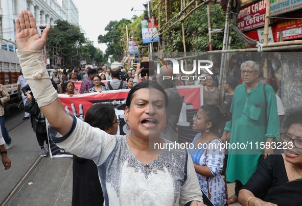 Indian artists protest with their paintings while they shout slogans during a protest rally against the rape and murder of a PGT woman docto...