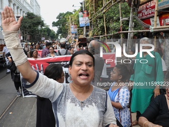 Indian artists protest with their paintings while they shout slogans during a protest rally against the rape and murder of a PGT woman docto...