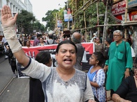 Indian artists protest with their paintings while they shout slogans during a protest rally against the rape and murder of a PGT woman docto...