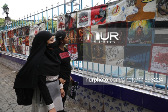 Indian artists protest with their paintings while they shout slogans during a protest rally against the rape and murder of a PGT woman docto...