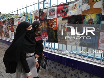 Indian artists protest with their paintings while they shout slogans during a protest rally against the rape and murder of a PGT woman docto...