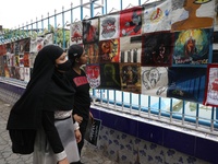 Indian artists protest with their paintings while they shout slogans during a protest rally against the rape and murder of a PGT woman docto...