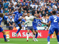 Wilfred Ndidi of Leicester City battles for possession with Dwight McNeil of Everton during the Premier League match between Leicester City...