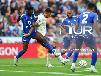 Wilfred Ndidi of Leicester City battles for possession with Dwight McNeil of Everton during the Premier League match between Leicester City...