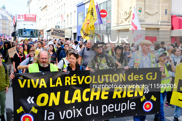 People during a protest against the ''Macron-Barnier'' government, in Paris, on September 21, 2024. France's new premier said he hoped to fi...