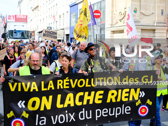 People during a protest against the ''Macron-Barnier'' government, in Paris, on September 21, 2024. France's new premier said he hoped to fi...