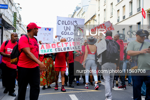 People during a protest against the ''Macron-Barnier'' government, in Paris, on September 21, 2024. France's new premier said he hoped to fi...