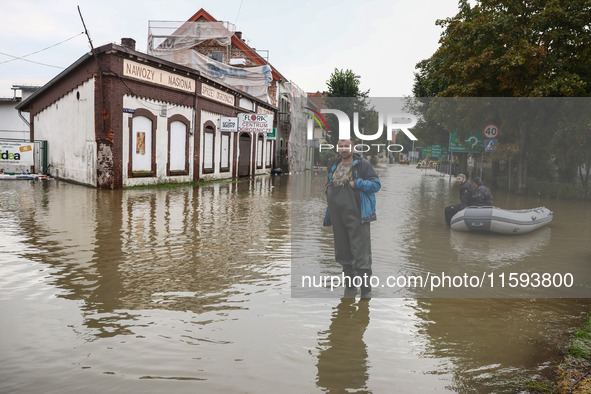 A man stands in the water after Nysa Klodzka river flooded town of Lewin Brzeski in southwestern Poland, on September 19th, 2024. Storm Bori...