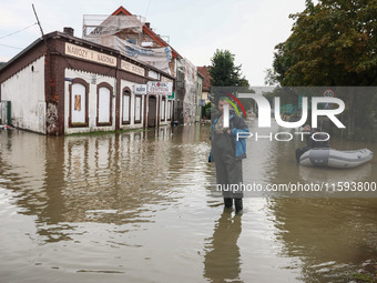 A man stands in the water after Nysa Klodzka river flooded town of Lewin Brzeski in southwestern Poland, on September 19th, 2024. Storm Bori...