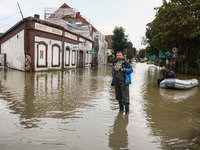 A man stands in the water after Nysa Klodzka river flooded town of Lewin Brzeski in southwestern Poland, on September 19th, 2024. Storm Bori...