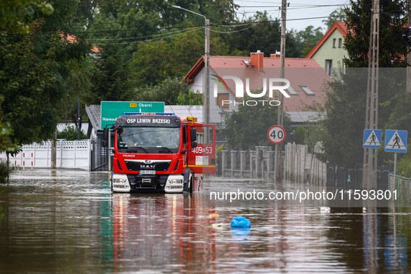 A fire truck drives in the water after Nysa Klodzka river flooded town of Lewin Brzeski in southwestern Poland, on September 19th, 2024. Sto...