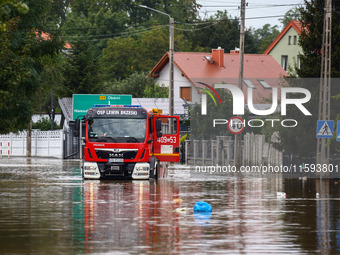 A fire truck drives in the water after Nysa Klodzka river flooded town of Lewin Brzeski in southwestern Poland, on September 19th, 2024. Sto...