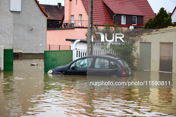 A car is seen in the water after Nysa Klodzka river flooded town of Lewin Brzeski in southwestern Poland, on September 19th, 2024. Storm Bor...