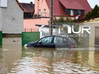 A car is seen in the water after Nysa Klodzka river flooded town of Lewin Brzeski in southwestern Poland, on September 19th, 2024. Storm Bor...